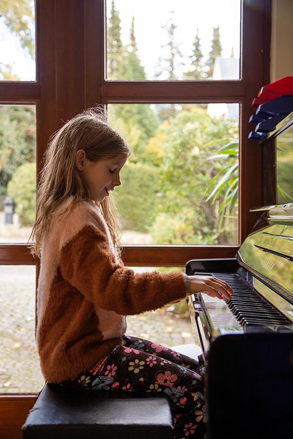 International Montessori Schools - Student playing the piano